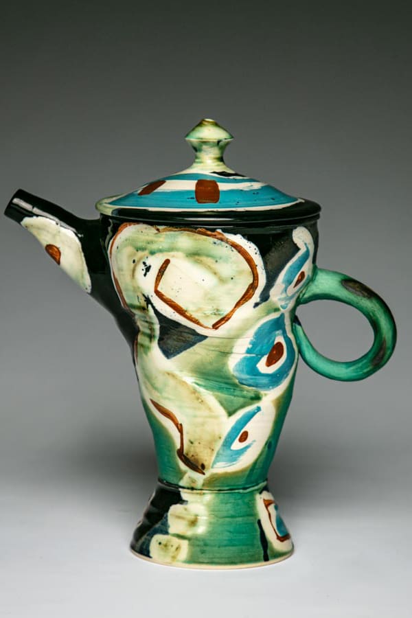 A whimsical coffee pot with lid